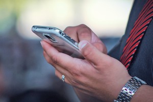 man using a phone to report a fault