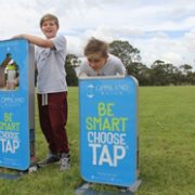 Boys drinking from Water Stations