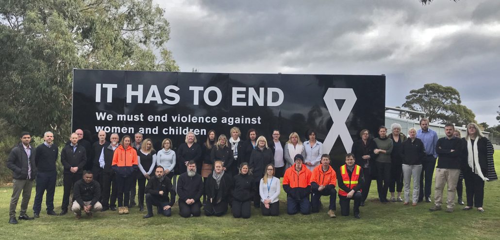 Image of Westernport Water staff standing in front of White Ribbon billboard sign