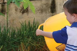 Kid watering garden