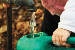 Tap running watering can