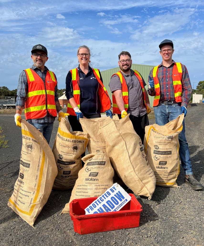 Four Westernport Water stand with 6 large bags of rubbish collected during the clean up.