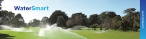 Sprinklers on golf course watering the lawn